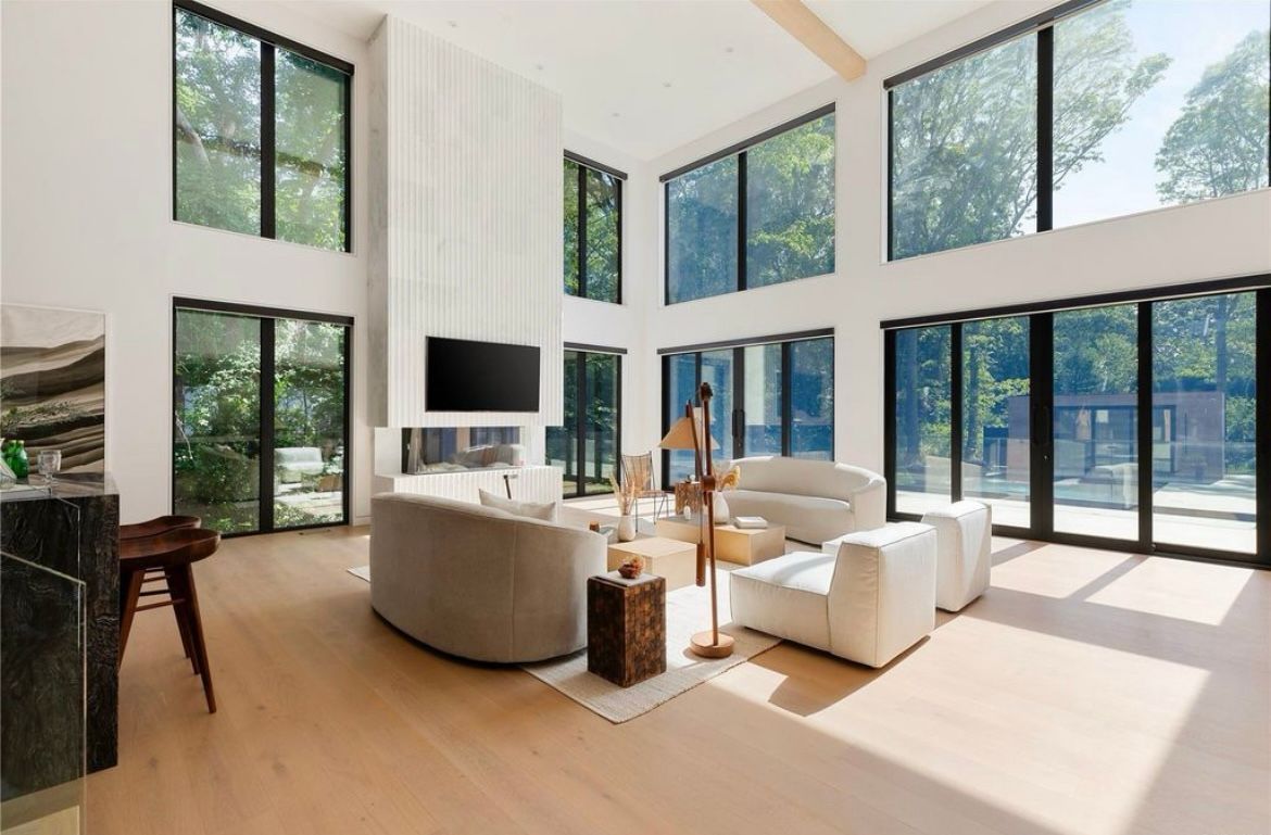 A living room with a lot of windows and furniture