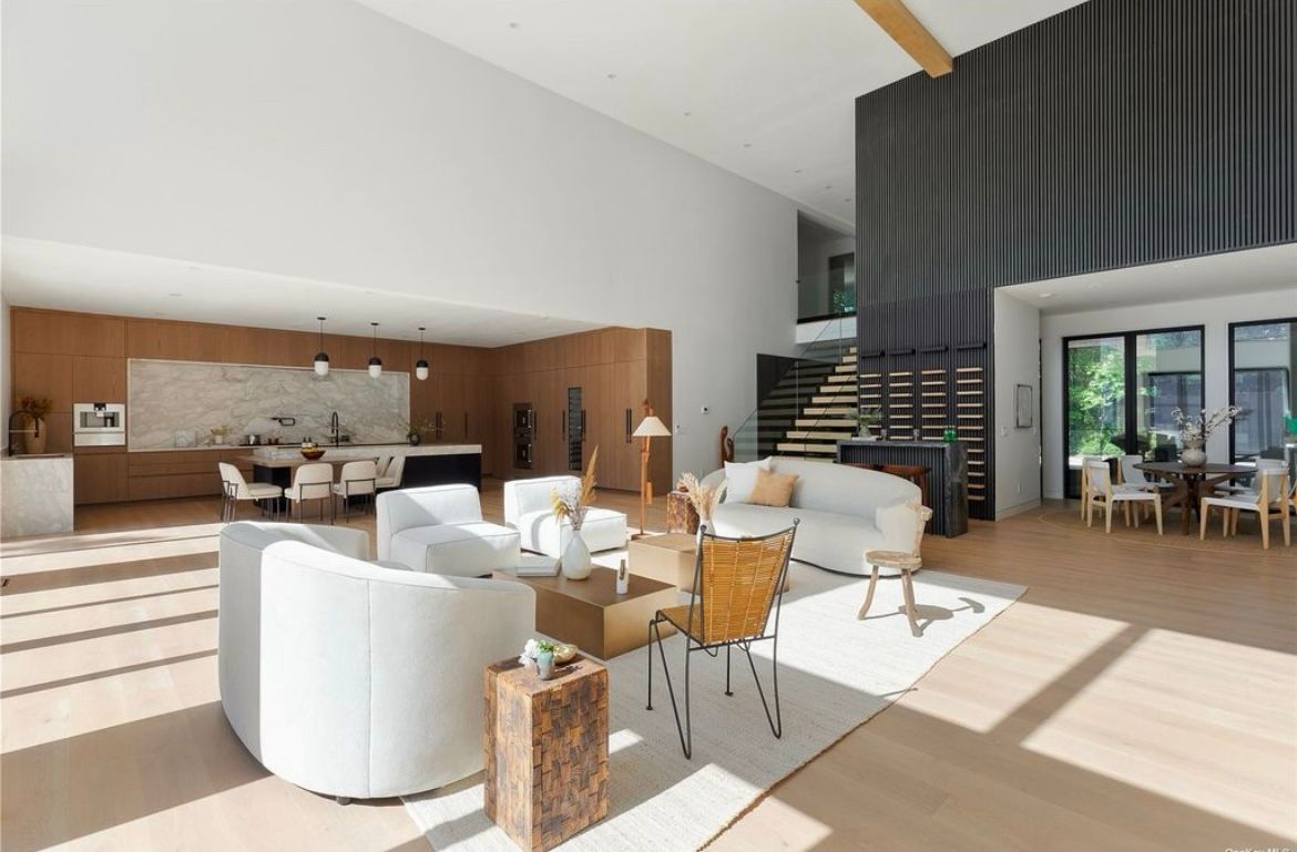 A living room with a couch, chairs, and a table