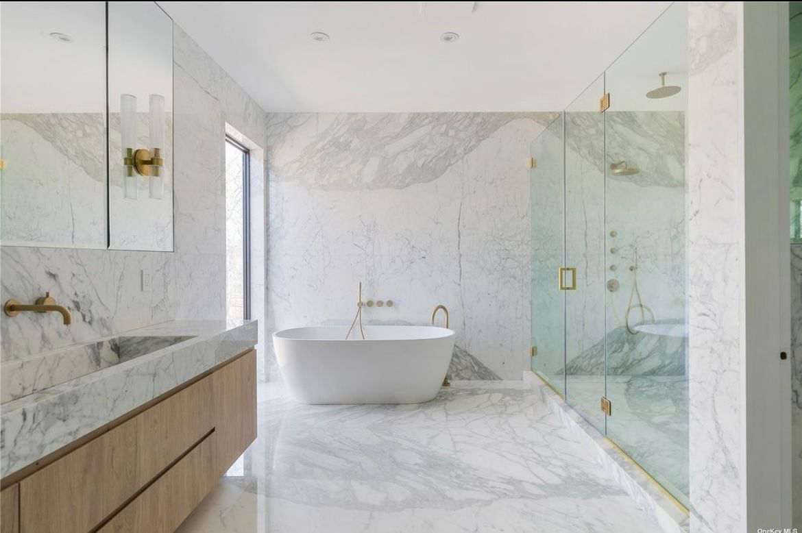 A bathroom with a bathtub, sink, and shower