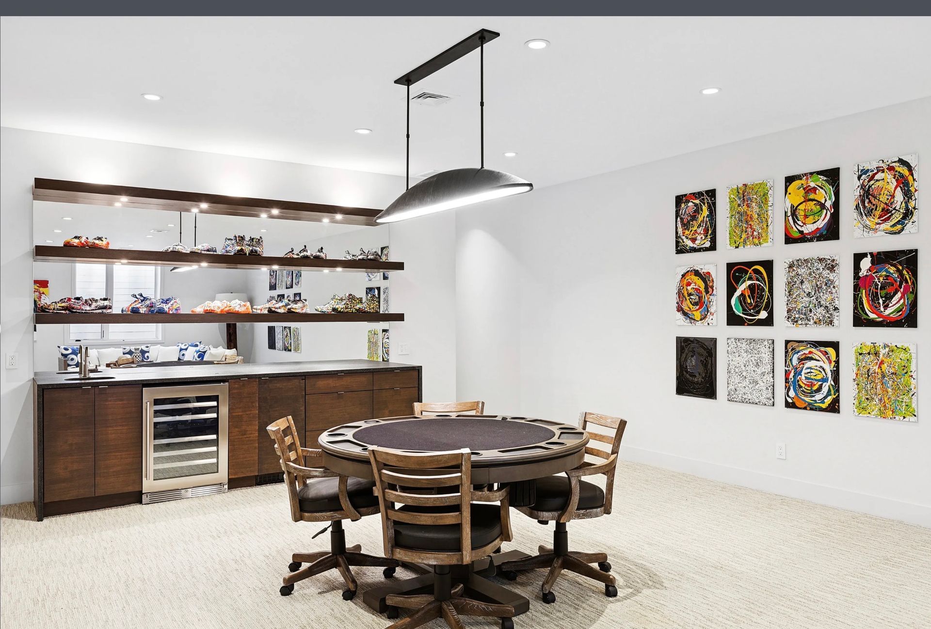Modern kitchen and dining area with wooden table, open shelves, and colorful wall art.