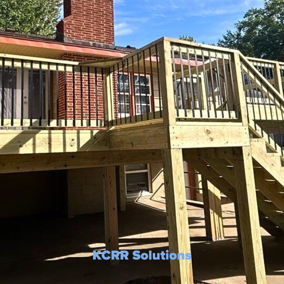Photo of a newly rebuilt deck featuring wooden supports and black metal railings. The stairs are fully restored, and the repaired roofline above the deck enhances the home's appearance after storm damage repairs. The deck looks sturdy and modern.