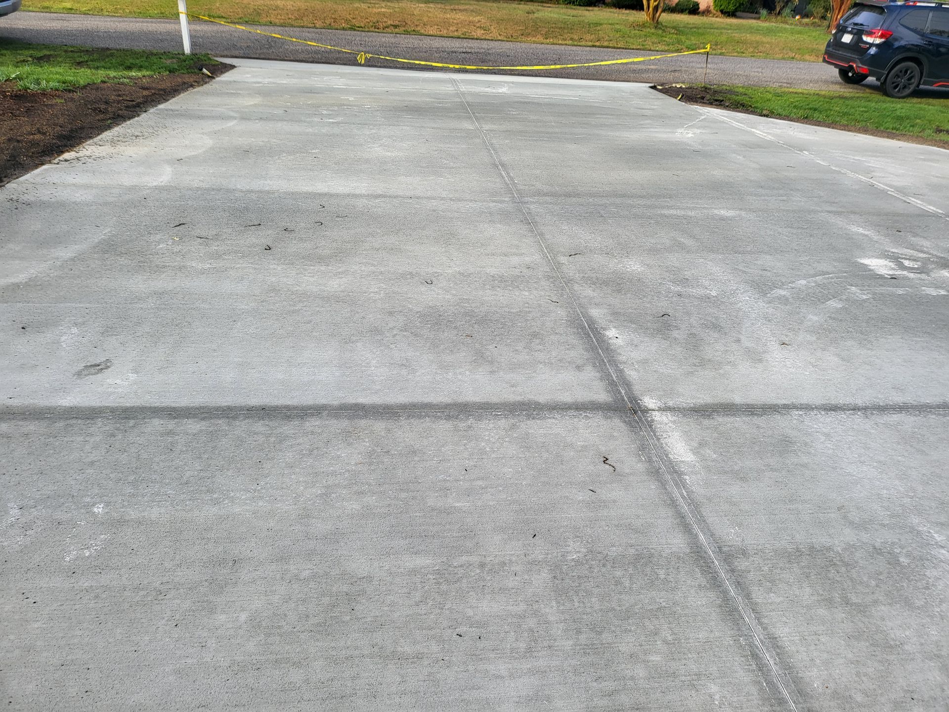 Concrete driveway with visible expansion joints.