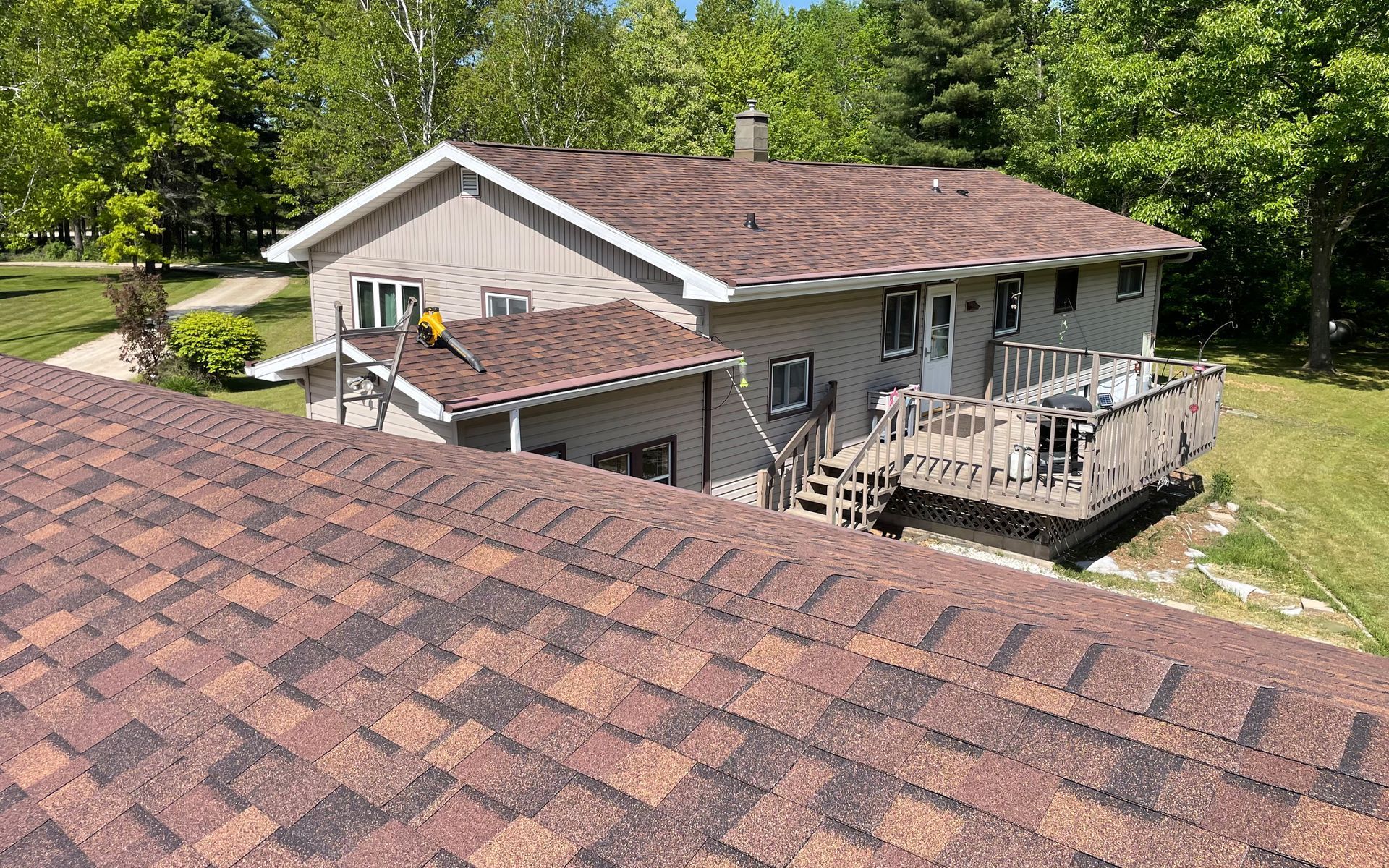 An aerial view of a house with a roof and a deck.