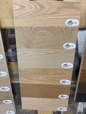 A row of wooden boards with different shades of wood.