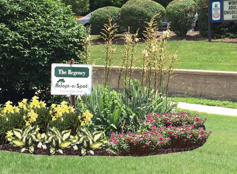 A garden with flowers and a sign that says the legacy