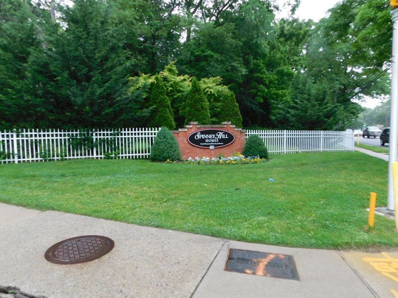 Before photo of a sign in the middle of a lush green field says Dream Rd