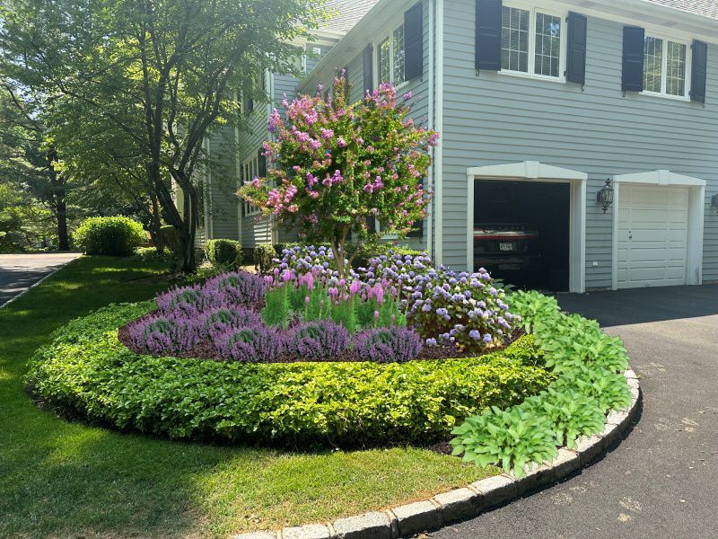 A house with a circular garden in front of it