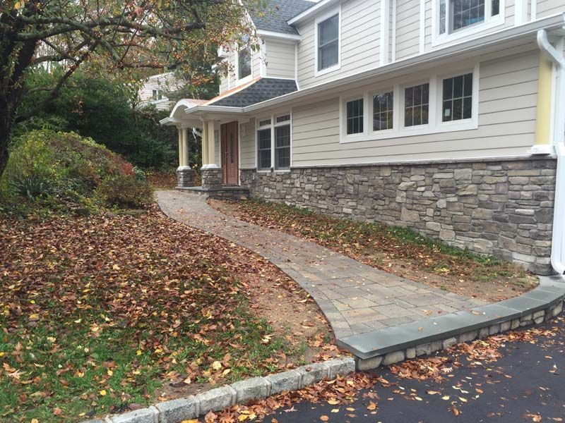 A house with a stone walkway leading to it