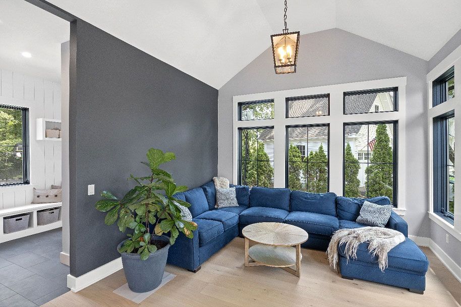 A living room with a blue sectional couch and a coffee table