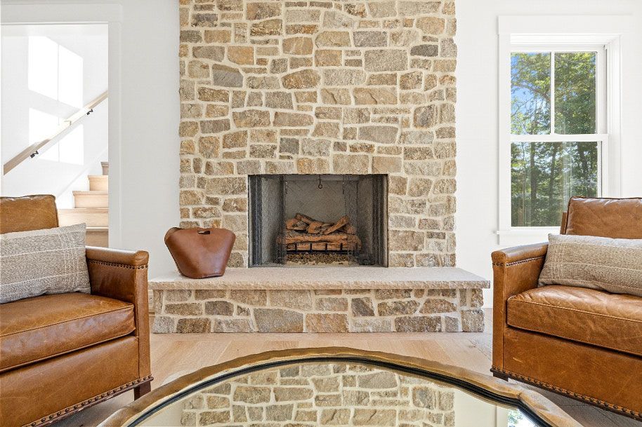 There is a fireplace in the middle of the living room