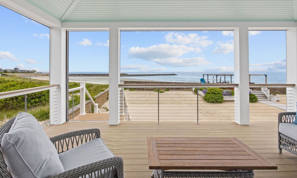 There is a large deck with a view of the ocean.