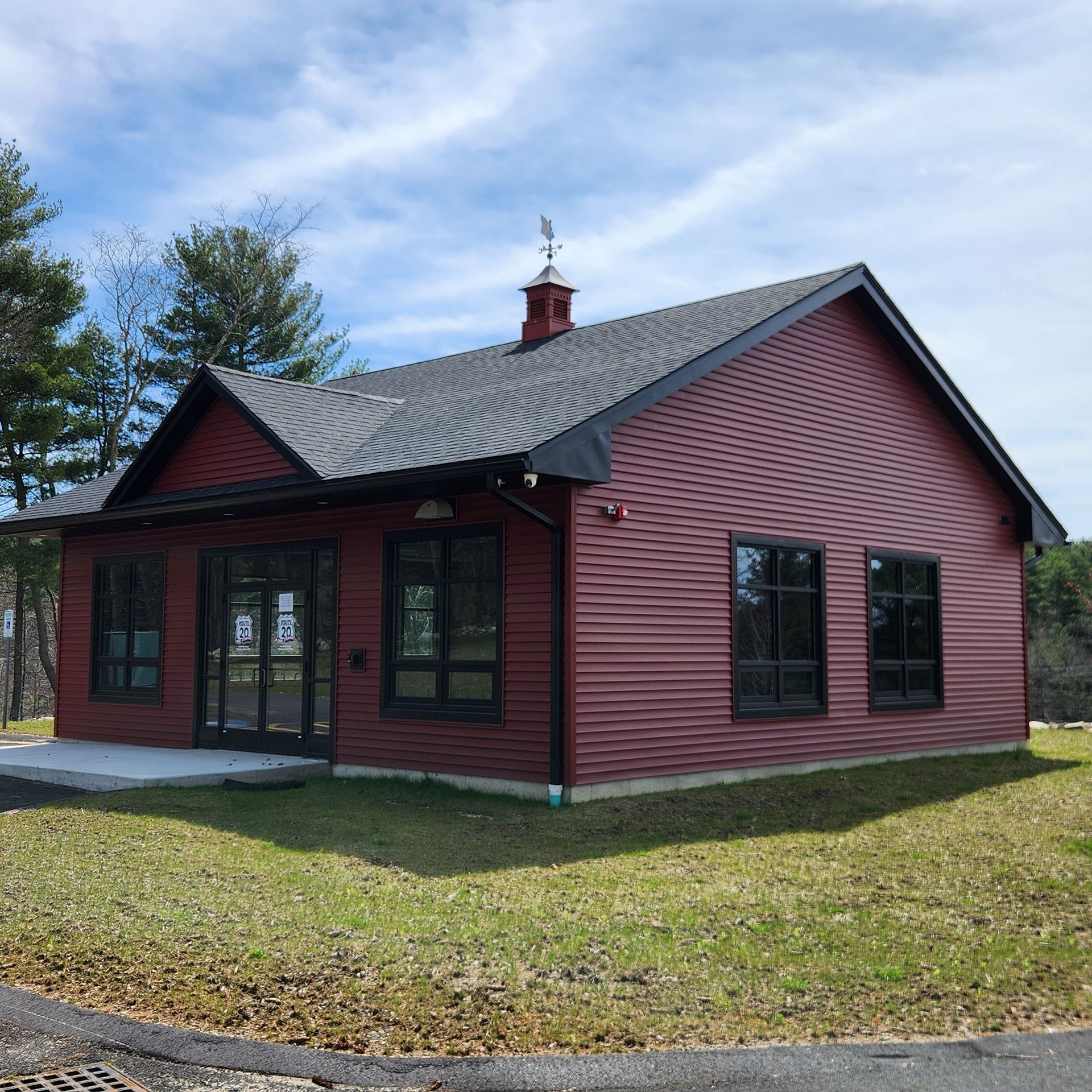 A small red house with a chimney on top of it