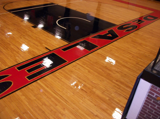 Basketball court with red and black lettering spelling 