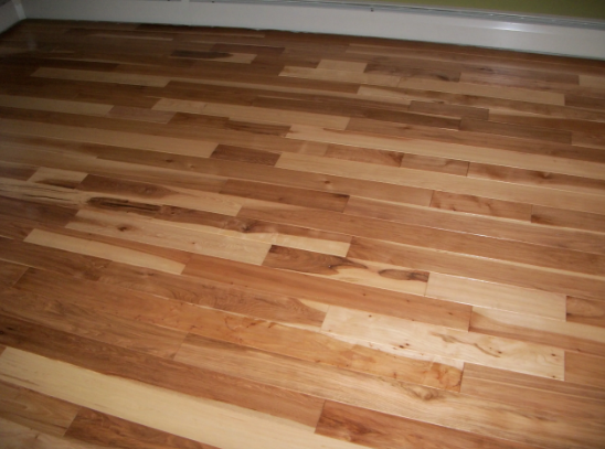 Wood flooring with varying shades of brown and natural wood grain.