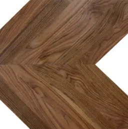 Close-up of brown wooden chevron flooring pattern.