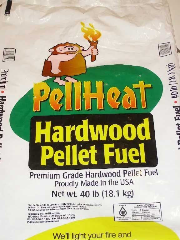 Bag of PellHeat hardwood pellet fuel with cartoon caveman holding a torch.