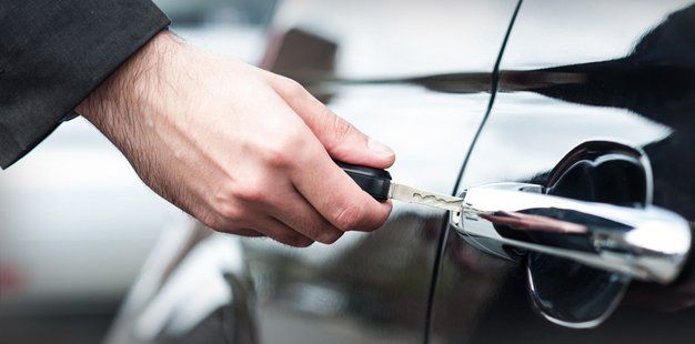 holding car key