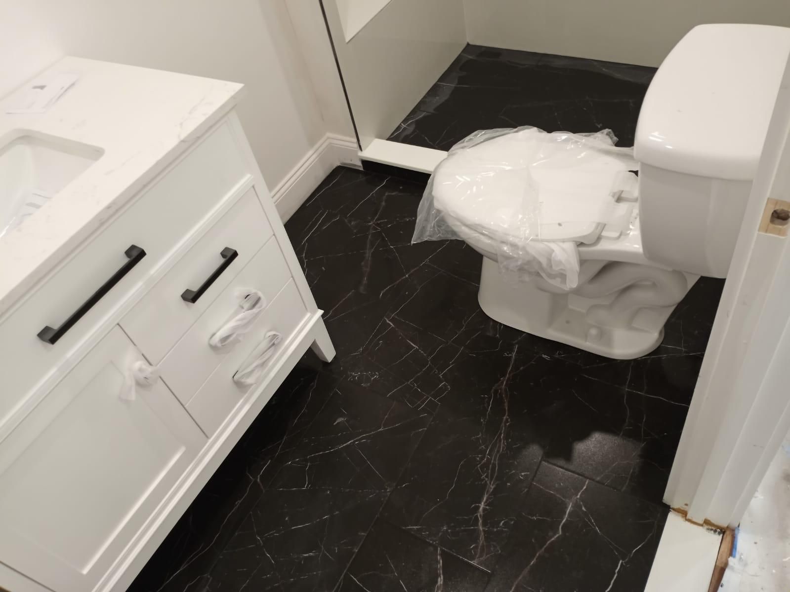 A bathroom with a toilet and a sink in it