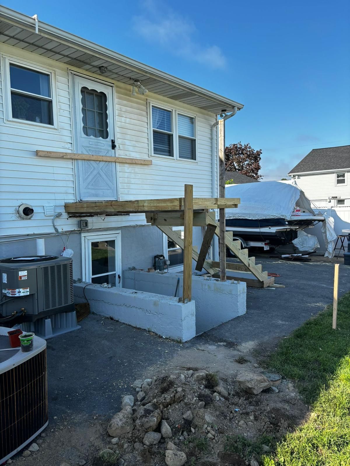 A white house with a wooden deck.