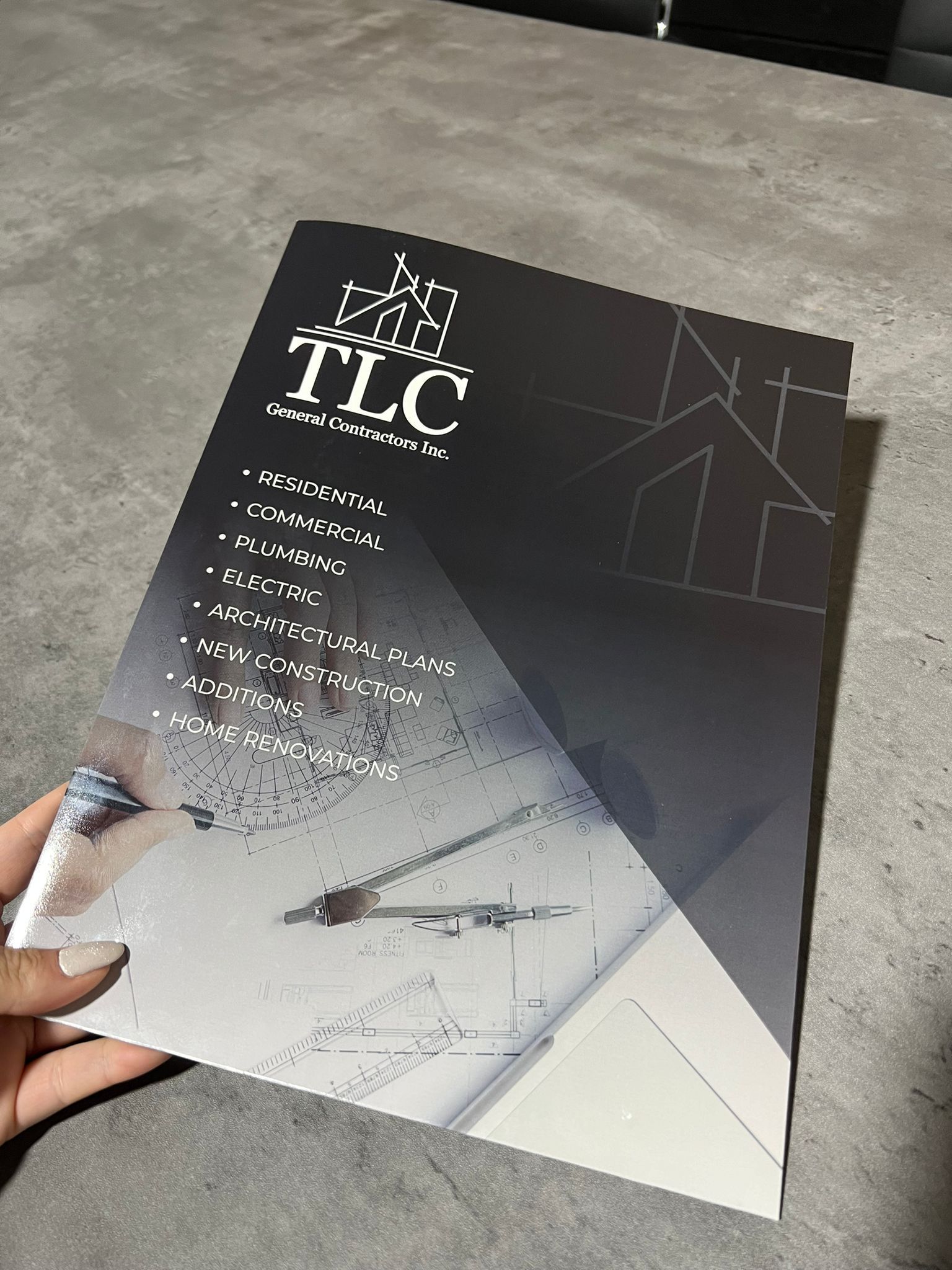 A person is holding a piece of paper flyer.