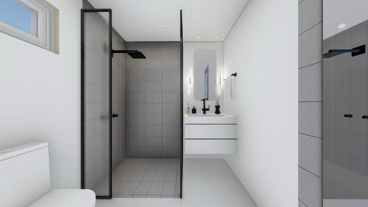 A bathroom with a toilet , sink and shower.