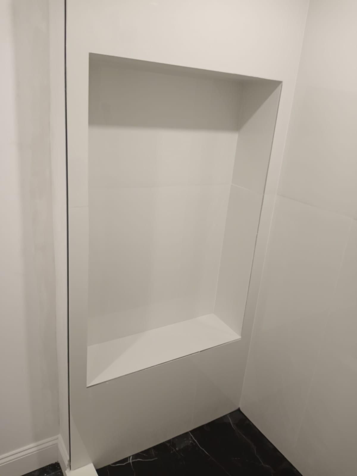 There is a niche in the wall in the bathroom.