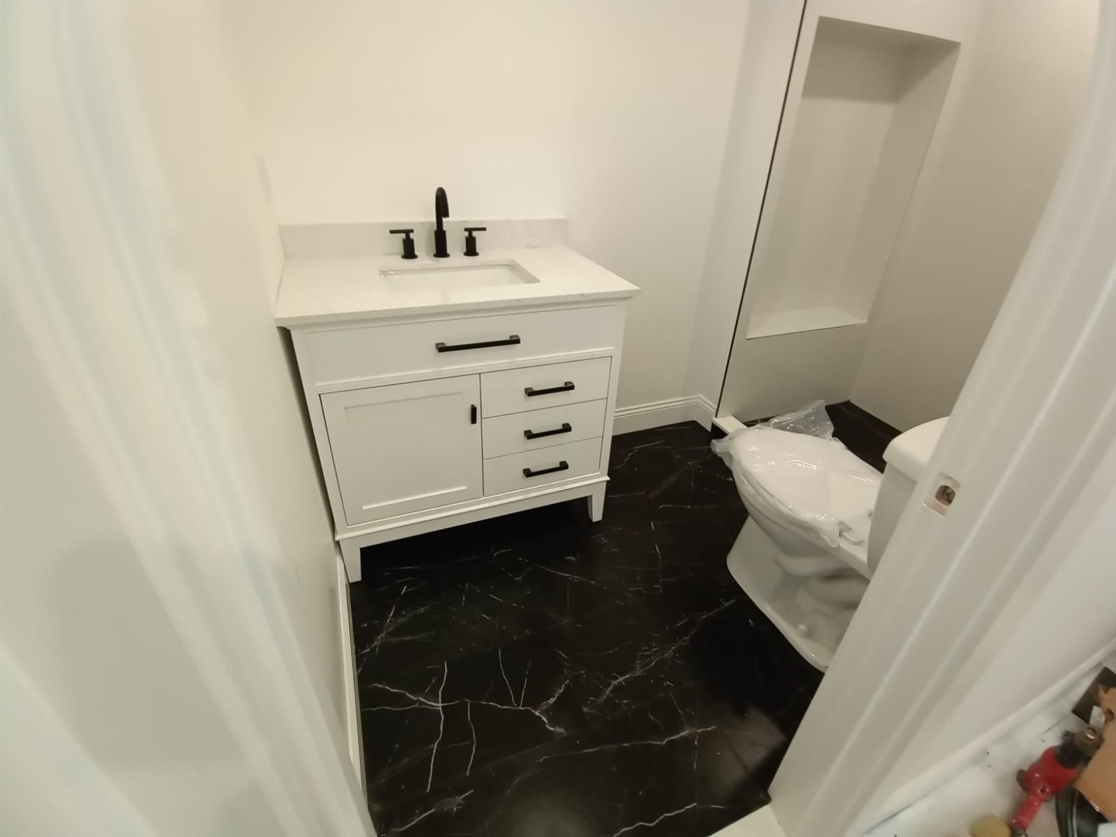A bathroom with a sink and toilet in it
