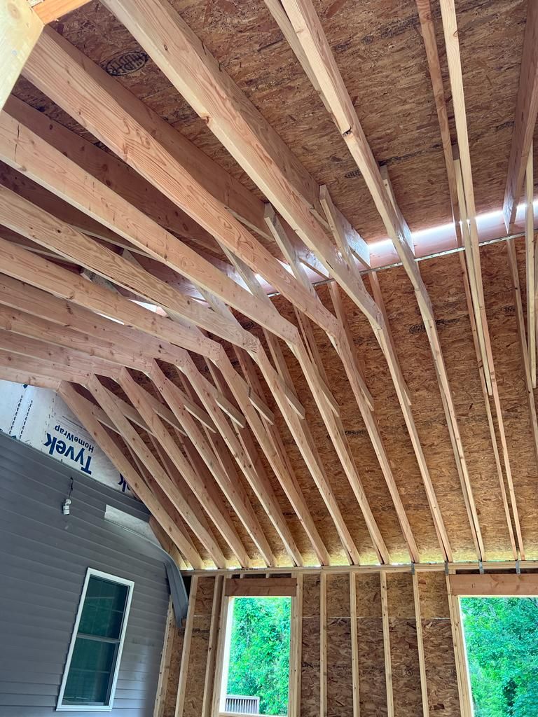 The ceiling of a house is being built with wooden beams.