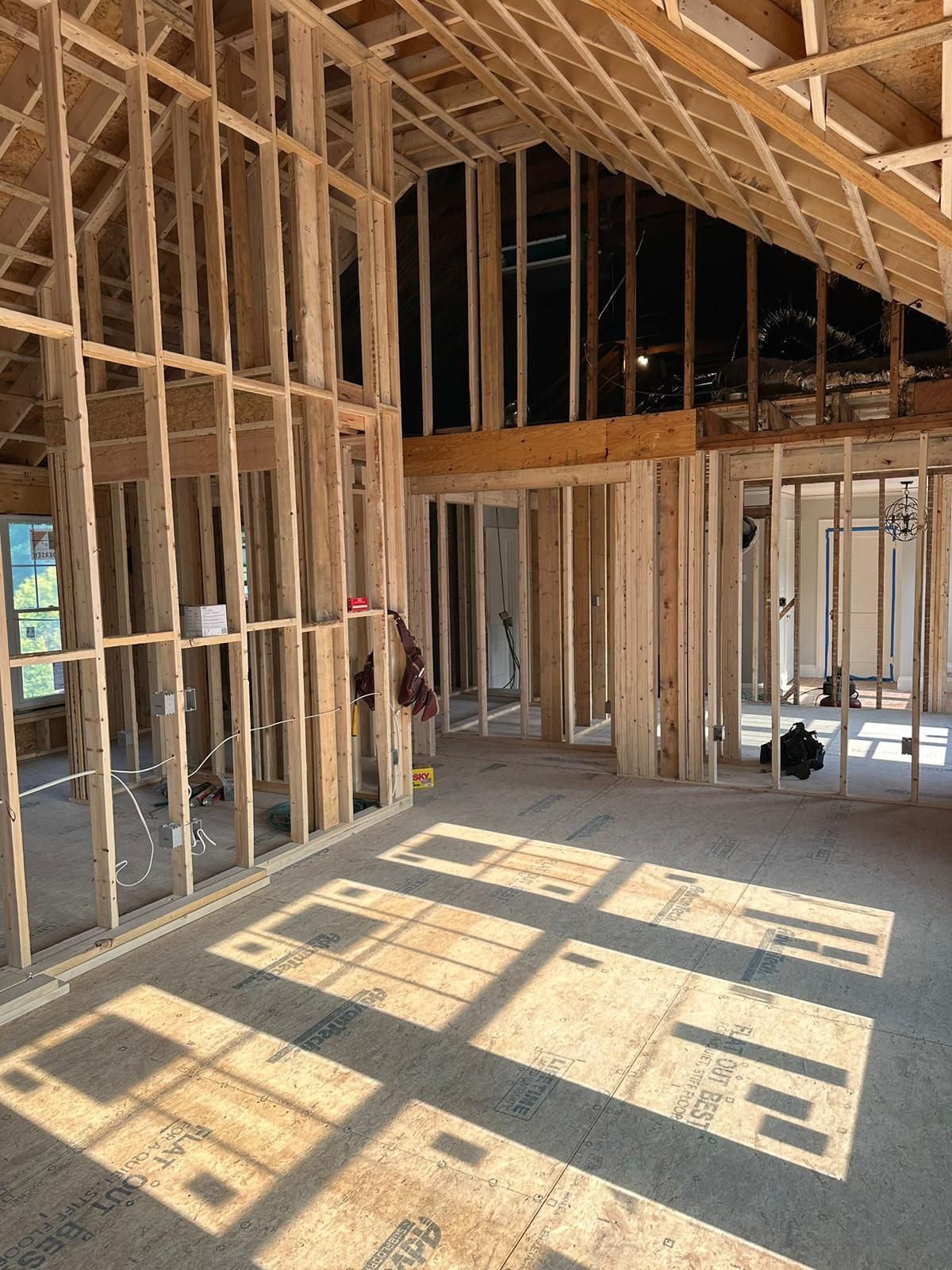 The inside of a building under construction with a lot of wooden beams.