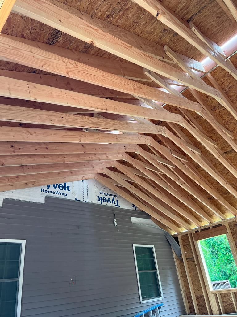 The ceiling of a house is being built with wooden beams.