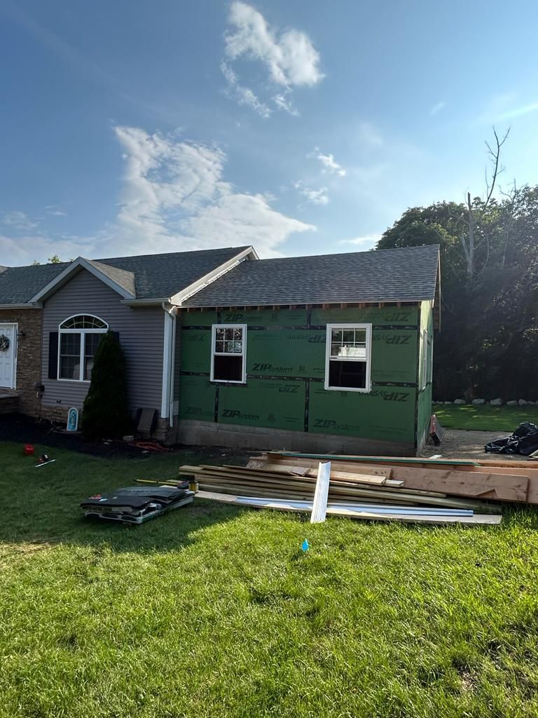 A house is being remodeled in a backyard.