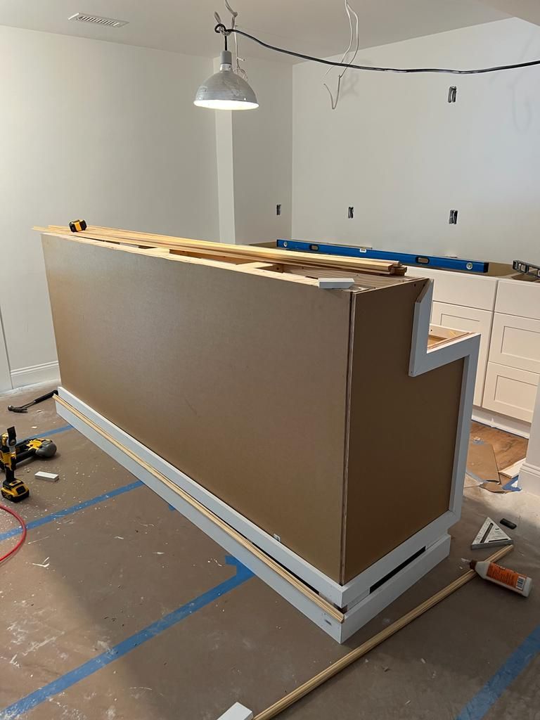 A large piece of cardboard is sitting on the floor in a room.