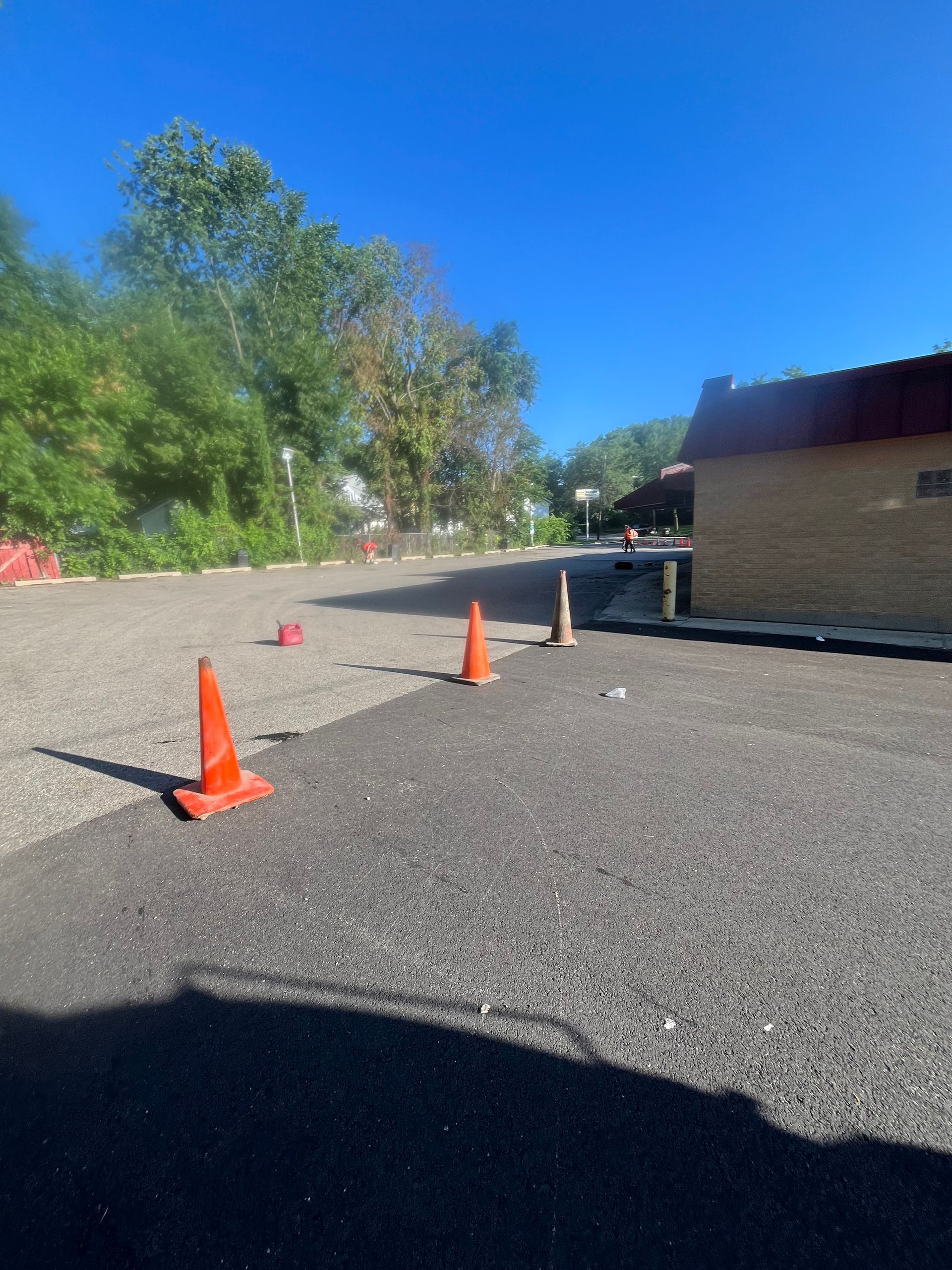 A row of orange traffic cones in a parking lot