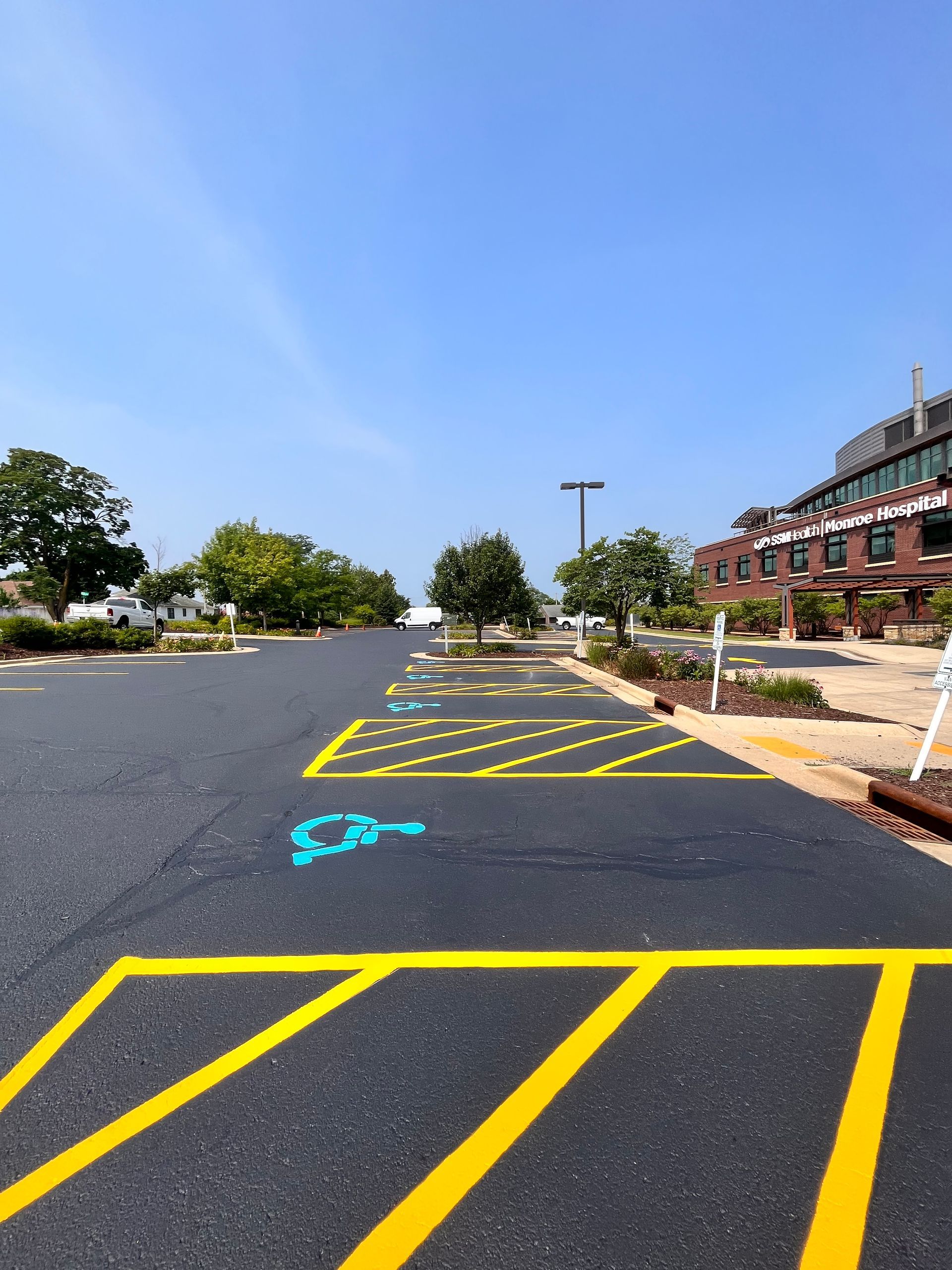 A handicapped parking spot is painted on the side of the road