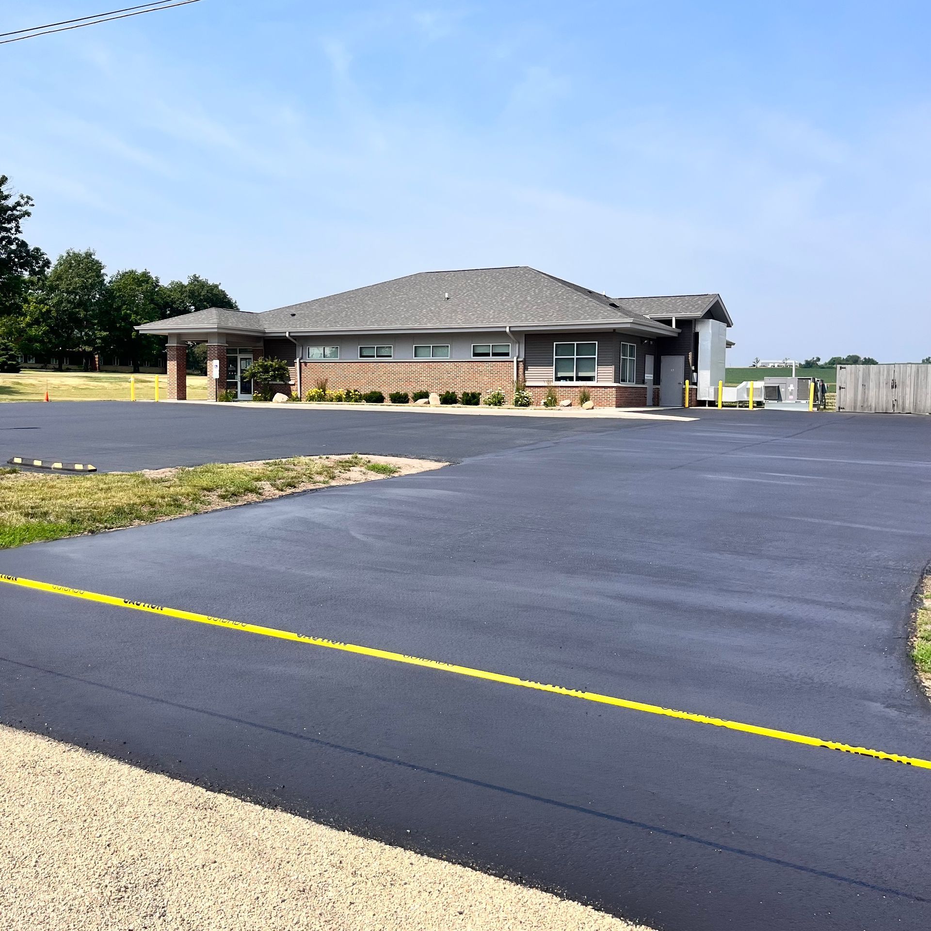 A large brick building sits in the middle of a parking lot