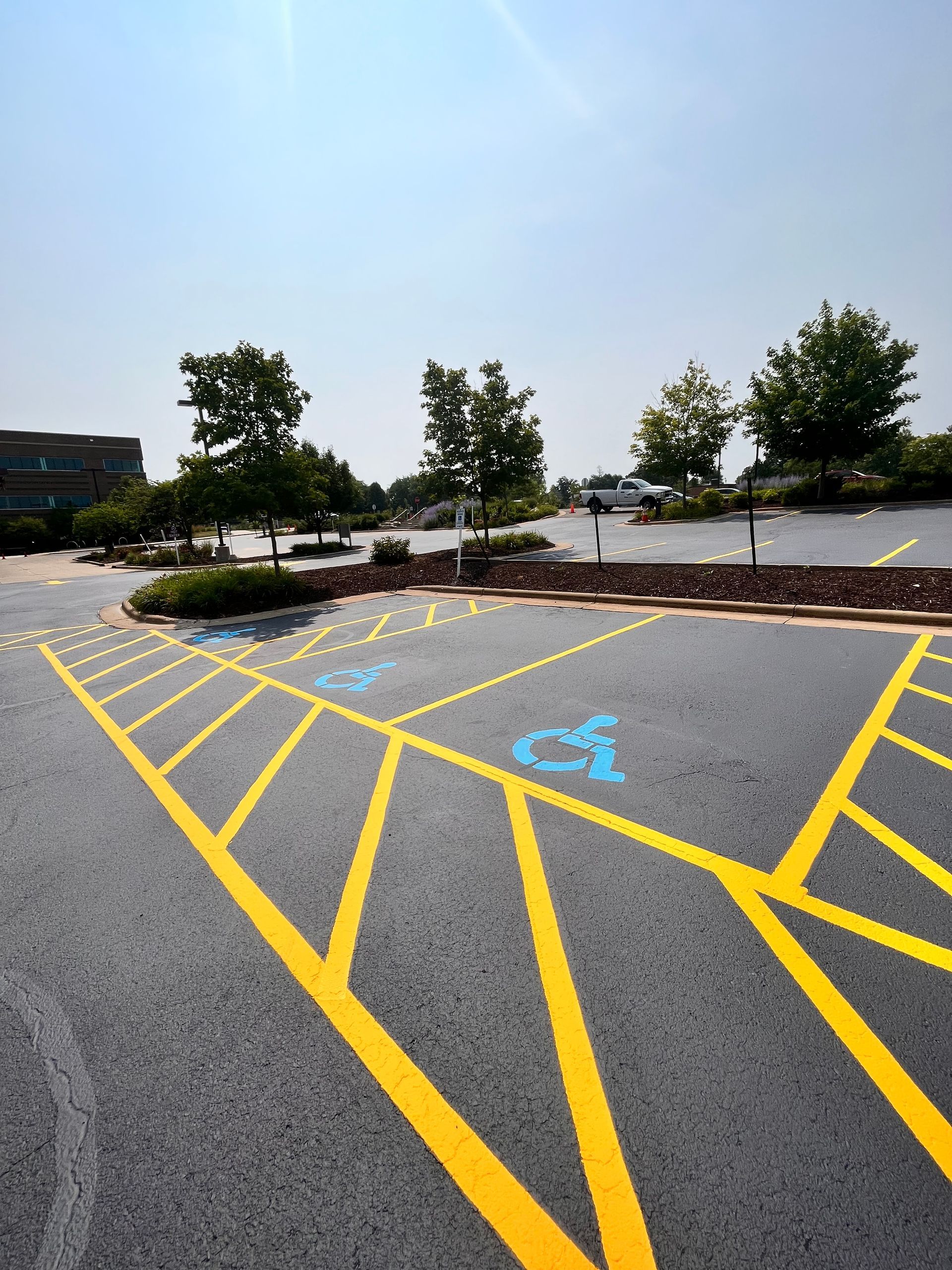 A parking lot with a handicapped parking spot painted in blue