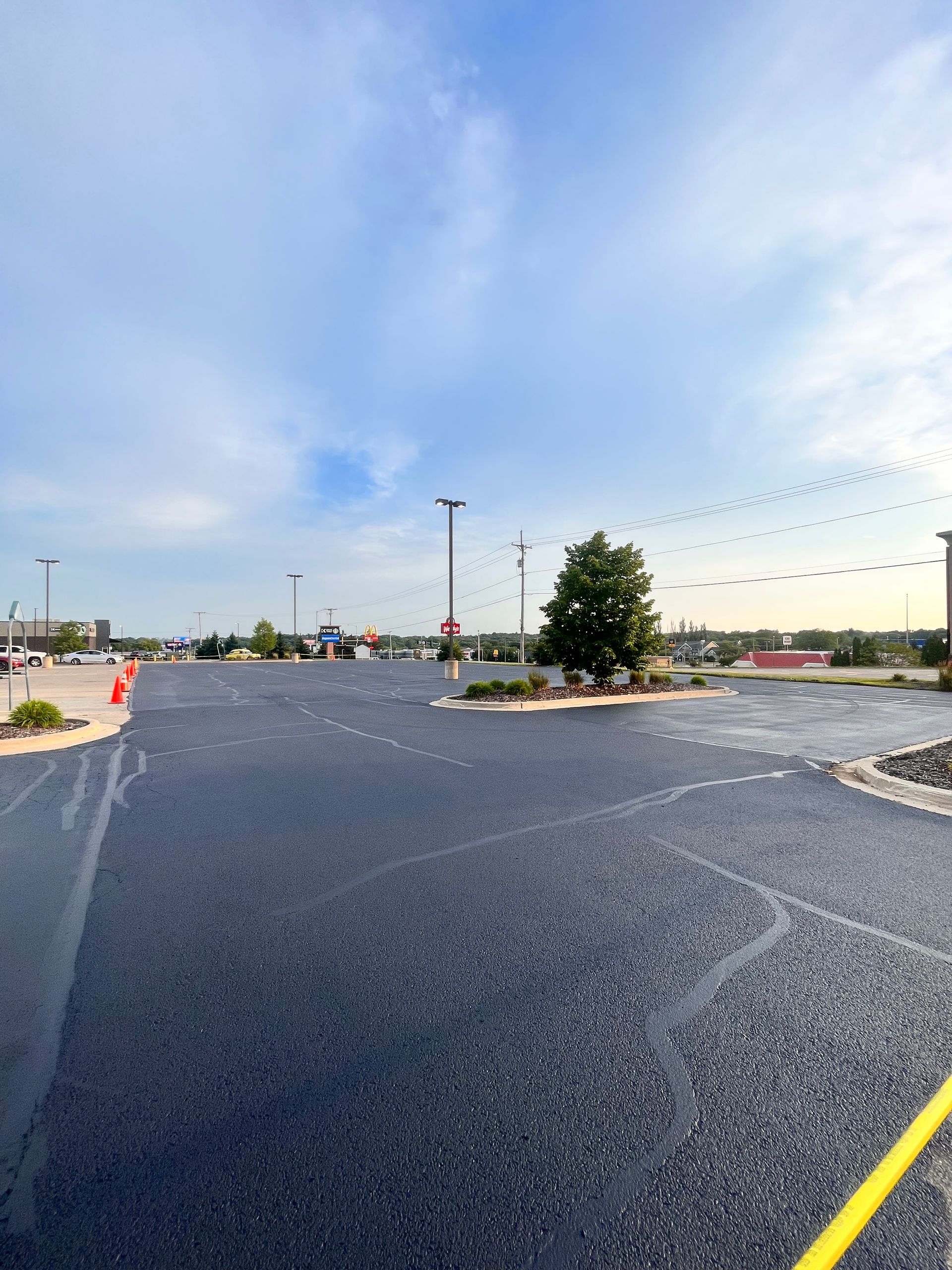 A parking lot with a yellow line on the side of it
