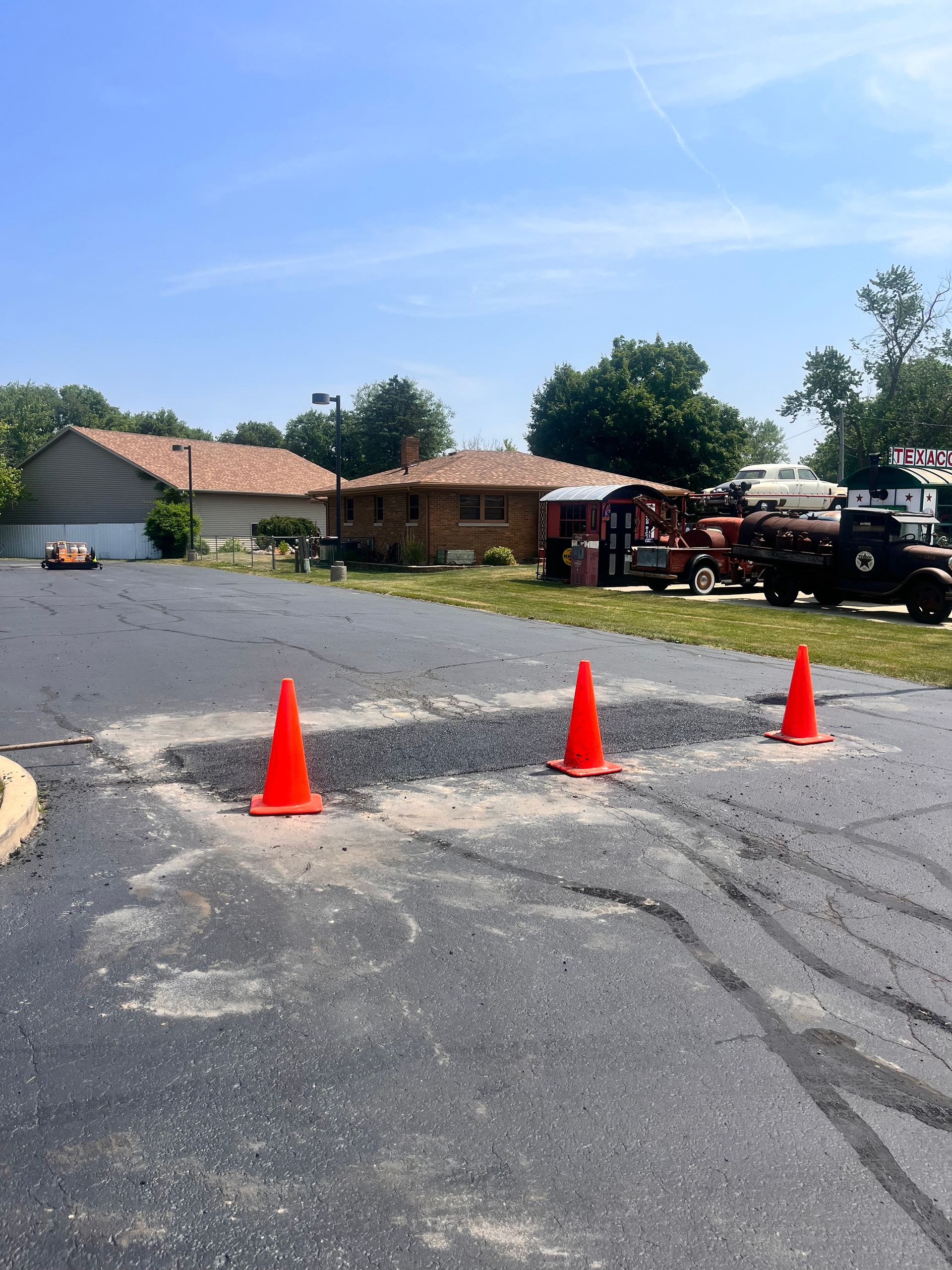A row of orange traffic cones in a parking lot