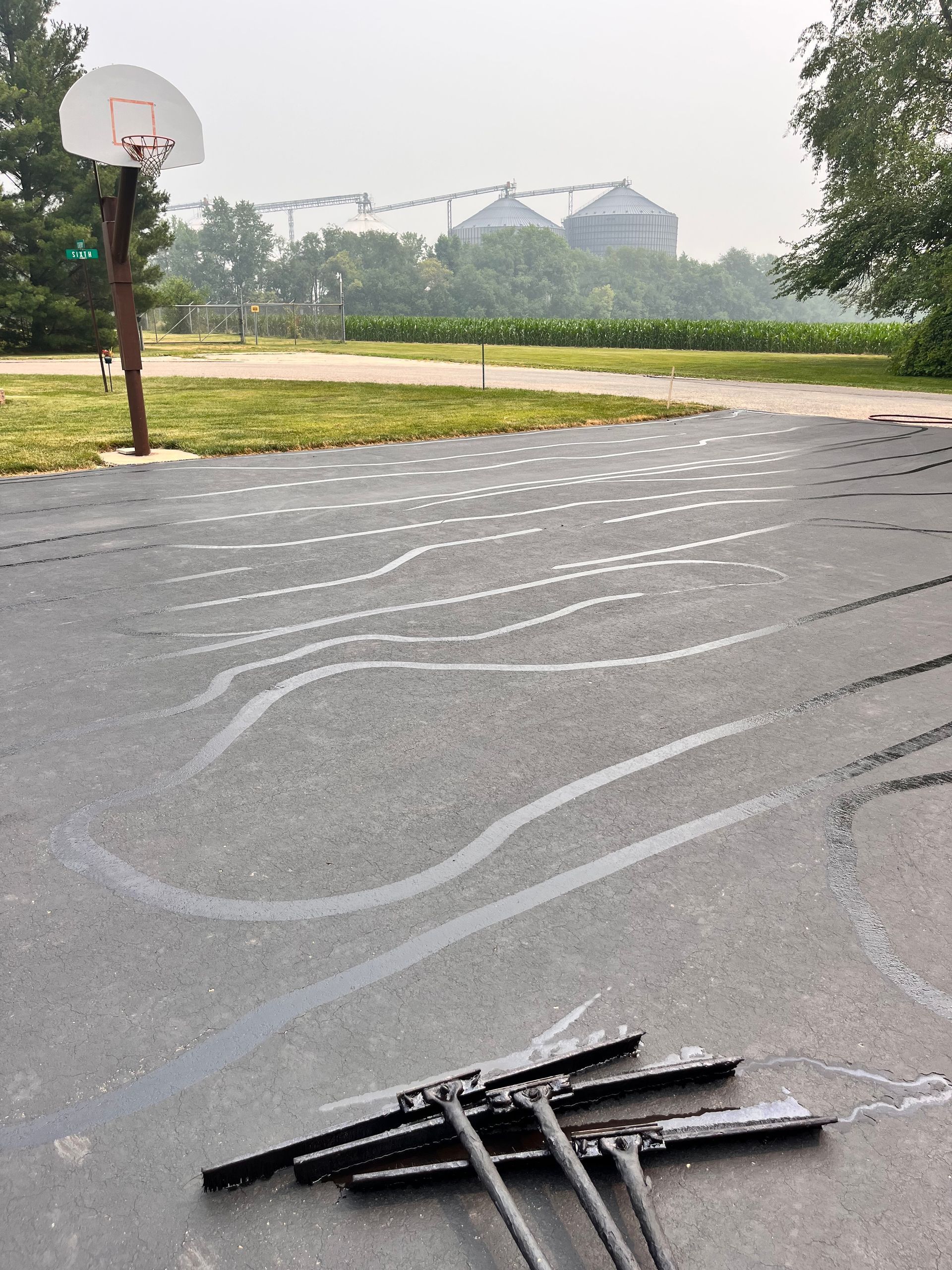 A basketball court with a basketball hoop in the background