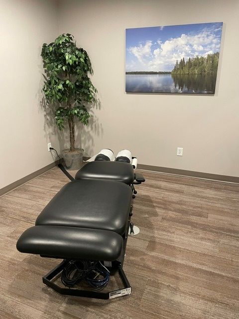 A room with a table and a picture on the wall