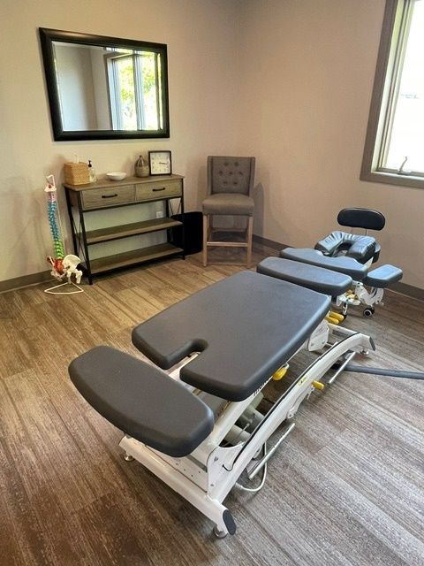 A room with a table and chairs and a mirror