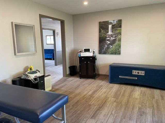 A room with a blue table and a picture on the wall