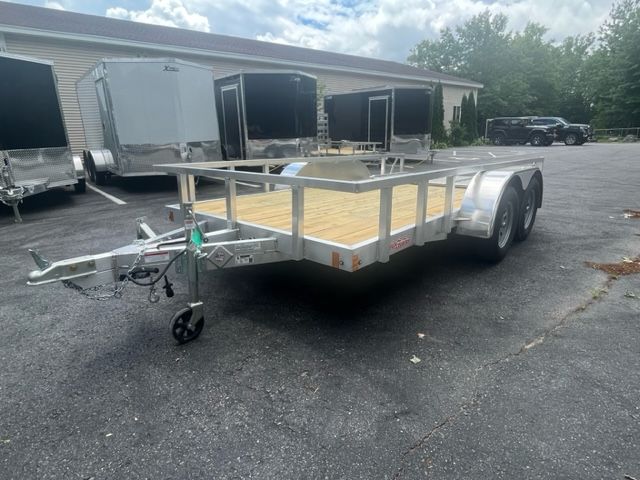 A trailer is parked in a parking lot in front of a building.
