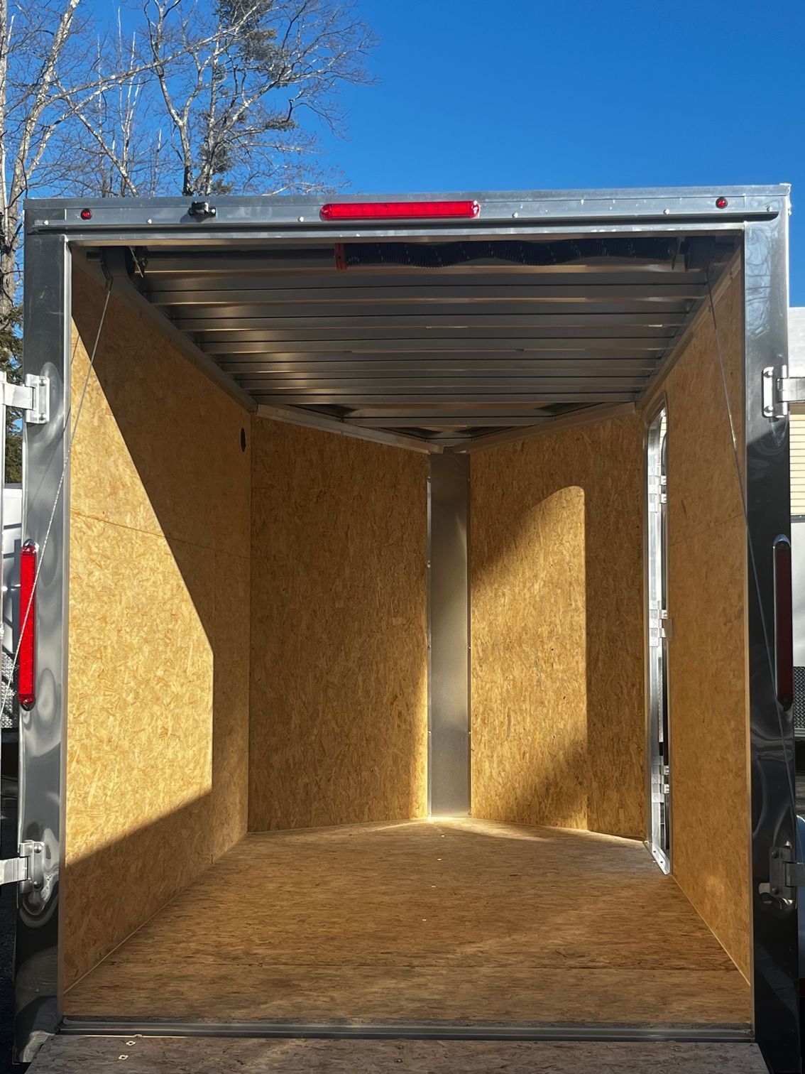 The inside of an empty trailer with the door open