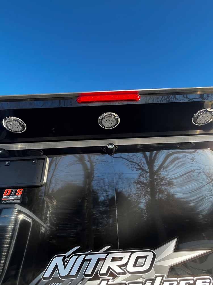 A close up of the rear end of a nitro truck with a blue sky in the background.