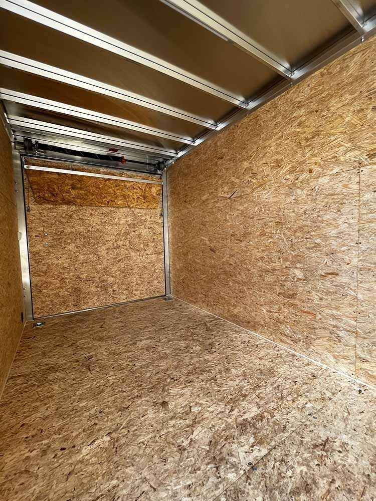 A large empty room with a wooden floor and walls.