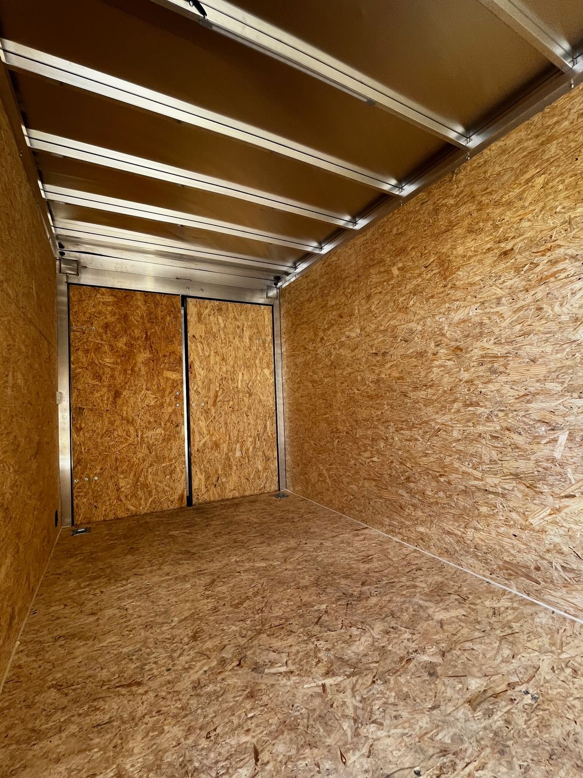 An empty room with a wooden floor and walls