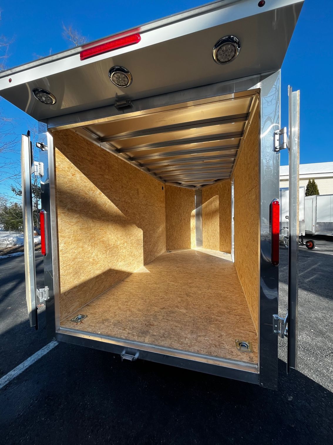 The inside of an empty trailer with the door open