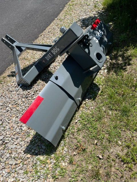 A bulldozer is sitting on a gravel road