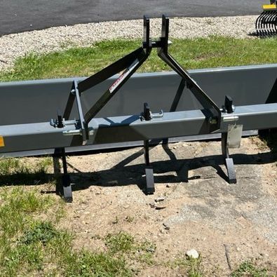 A large piece of metal is sitting on the ground in the grass.